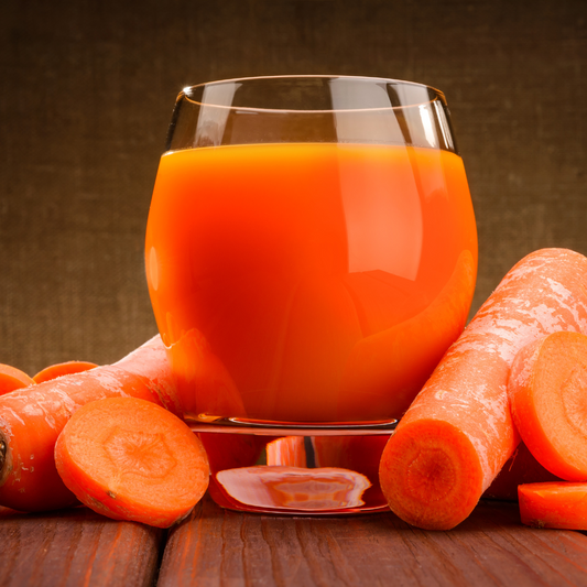 Close-up of fine orange carrot powder in a wooden spoon
